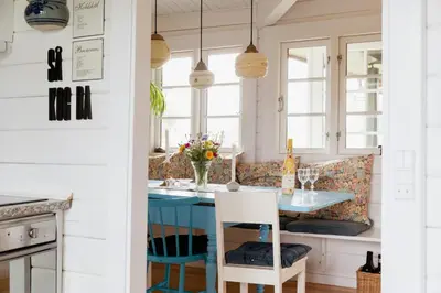 a kitchen with a blue table and chairs at Grandma's House By Limfjord And Fur in Roslev