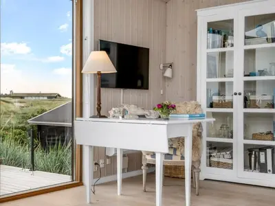 a white desk in a room with a mirror at Holiday Home Bjerund - 300m from the sea by Interhome in Løkken