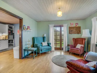 a living room with two chairs and a couch at Holiday Home Star - 200m to the fjord by Interhome in Farsø