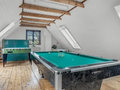 a room with a pool table in a attic at Holiday Home Star - 200m to the fjord by Interhome in Farsø