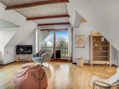 a living room with a couch and a chair at Holiday Home Star - 200m to the fjord by Interhome in Farsø