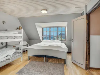 a bedroom with two beds and a window at Holiday Home Star - 200m to the fjord by Interhome in Farsø
