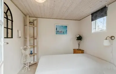 a bedroom with a white bed and a window at Amazing Home In Højslev With Sauna in Højslev