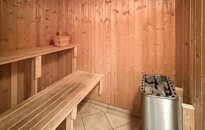 a sauna with a bench and a trash can at Amazing Home In Højslev With Sauna in Højslev
