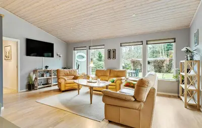 a living room with couches and a table at Amazing Home In Højslev With Sauna in Højslev