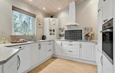 a white kitchen with white cabinets and a window at Amazing Home In Højslev With Sauna in Højslev