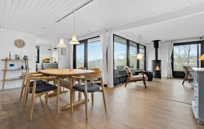 a kitchen and dining room with a table and chairs at Amazing Home In Spøttrup With Wifi in Lihme