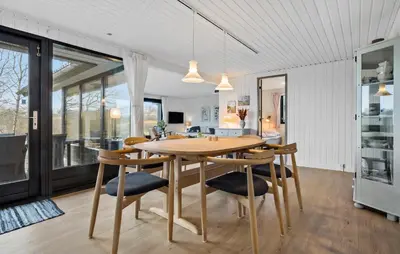 a kitchen and dining room with a wooden table and chairs at Amazing Home In Spøttrup With Wifi in Lihme