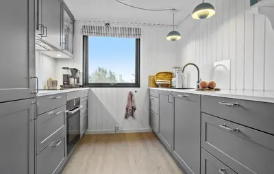 a kitchen with gray cabinets and a window at Amazing Home In Spøttrup With Wifi in Lihme