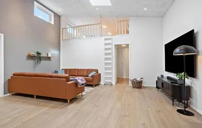 a living room with a couch and a tv at Nice Home In Højslev With Sauna in Højslev