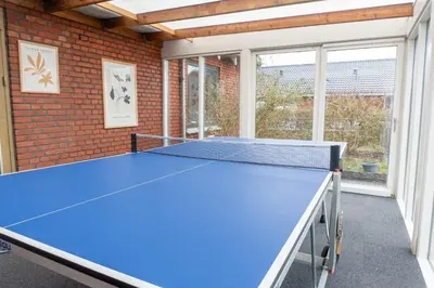 a ping pong table in a room with a brick wall at Villa Holstebro in Holstebro