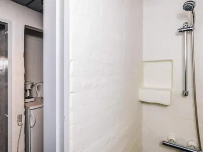 a bathroom with a towel rack on a wall at 6 person holiday home in Brovst in Brovst