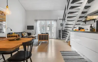 a kitchen and dining room with a table and stairs at Gorgeous Apartment In Vestervig in Vestervig