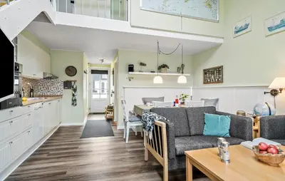 a kitchen and living room with a couch and a table at Gorgeous Home In Vestervig With Sauna in Vestervig