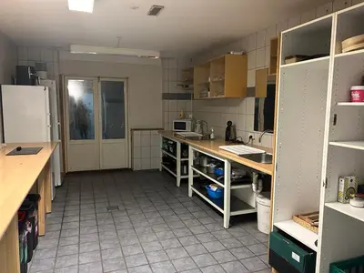 a kitchen with a counter and a refrigerator at Hostel Mors in Erslev