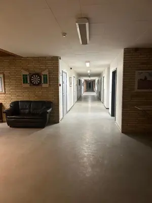 a long hallway with a couch in a room at Hostel Mors in Erslev