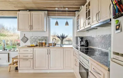 a kitchen with white cabinets and a large window at Gorgeous Home In Vinderup With Wifi in Vinderup