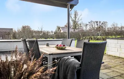 a wooden table and chairs on a patio at Gorgeous Home In Vinderup With Wifi in Vinderup