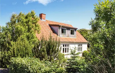 a white house with a red roof at Two-Bedroom Holiday Home Thyholm With Sea View 04 in Thyholm