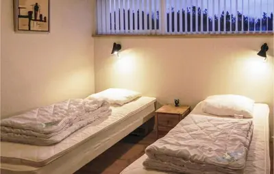 a room with two beds and a window at Three-Bedroom Holiday Home Hurup Thy With A Fireplace 06 in Sindrup