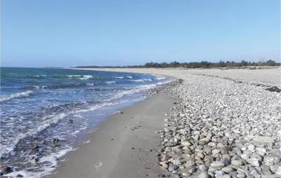 a beach with rocks and water on it at Three-Bedroom Holiday Home Hurup Thy With A Fireplace 06 in Sindrup