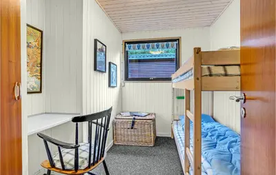 a small room with a bunk bed and a ladder at Two-Bedroom Holiday Home Nibe With A Fireplace 06 in Nibe