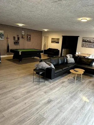 a living room with a couch and a pool table at Cozy Newly Renovated Apartment in Nørager