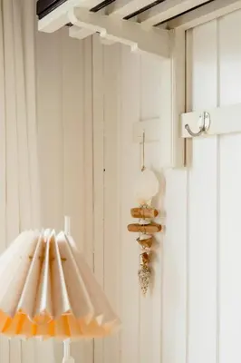 a room with two lamps and a white wall at Nordic 70S Gem Amidst The Dunes in Blokhus