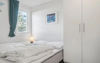 a white bedroom with a bed and a window at Cozy Home In Vestervig With Sauna in Vestervig