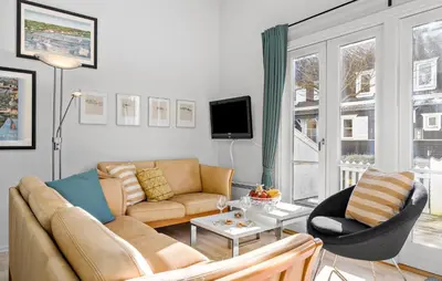 a living room with a couch and a chair at Cozy Home In Vestervig With Sauna in Vestervig