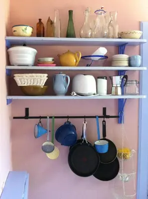 a shelf with pots and pans and other dishes at Romance And Sea View At Havbakken in Fjerritslev