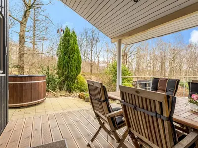 a patio with two chairs and a wooden table at Holiday Home Nico - 70m to the inlet by Interhome in Roslev