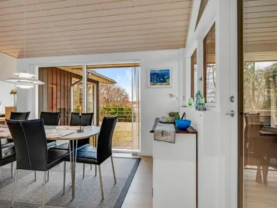a dining room and kitchen with a table and chairs at Holiday Home Nico - 70m to the inlet by Interhome in Roslev
