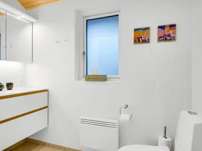 a white bathroom with a toilet and a window at Holiday Home Nico - 70m to the inlet by Interhome in Roslev