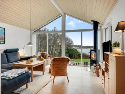 a living room with a couch and a fireplace at Holiday Home Nico - 70m to the inlet by Interhome in Roslev