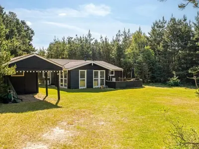 a home with a yard with a house at Holiday Home Hansa - 3km from the sea by Interhome in Blokhus