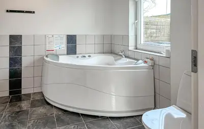a white bath tub in a bathroom with a window at Gorgeous Home In Thisted With Wifi in Thisted