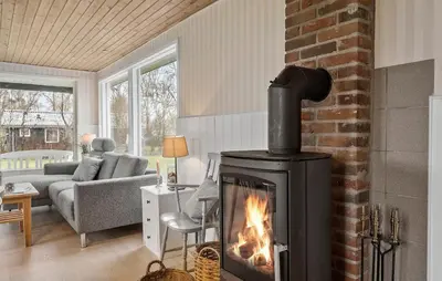 a living room with a fireplace and a couch at Nice Home In Vinderup With Wifi in Vinderup