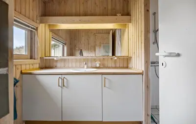 a bathroom with a white sink and a mirror at Cozy Home In Saltum With House Sea View in Saltum