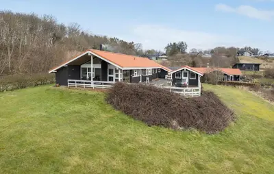 a house on top of a grassy hill at 3 Bedroom Amazing Home In Spøttrup in Spottrup