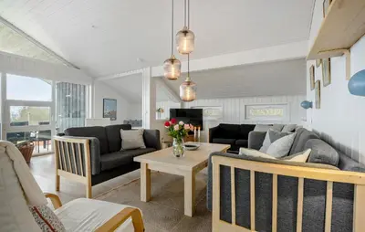 a living room with a couch and a table at 3 Bedroom Amazing Home In Spøttrup in Spottrup