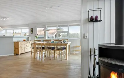 a kitchen and dining room with a table and chairs at 3 Bedroom Amazing Home In Spøttrup in Spottrup