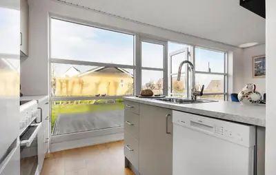 a kitchen with a sink and a large window at 3 Bedroom Cozy Home In Farsø in Farsø