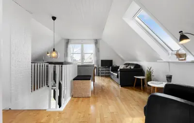 a living room with a couch and a table at 3 Bedroom Cozy Home In Farsø in Farsø
