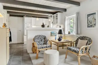 a living room with a table and two chairs at Natural Gem Between Heath And Dunes in Thisted