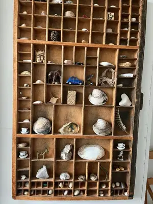 a wooden shelf filled with lots of hats and other items at Wooden House In The Dunes Close To The Sea in Pandrup