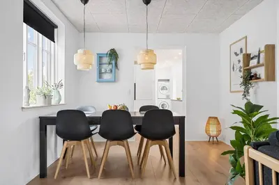 a dining room with a table and four chairs at Newly renovated house in the center in Thyborøn