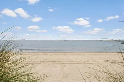 a beach with a view of the water at Newly renovated house in the center in Thyborøn