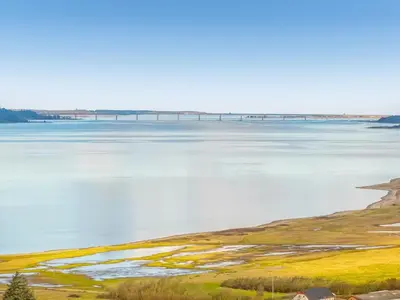 a large body of water with a bridge in the distance at Holiday Home Marika - 400m to the fjord by Interhome in Spottrup