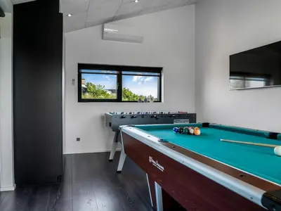 a billiard room with a pool table in it at Holiday Home Eriksine - 750m from the sea by Interhome in Løkken